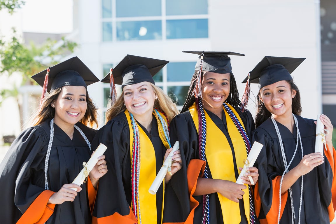 Four young women graduating from high school or college